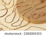Metal chains and other different accessories on beige background