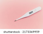 Small photo of Digital white thermometer with a normal temperature of 36 degrees centigrade on a pink background in the concept of control over health and new emerging viruses for women who are in advanced gestation