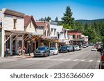Small photo of NEVADA CITY, CA, U.S.A. - JUNE 25, 2023: Photo of the shops and eateries along Broad Street with rainbow flags during Pride Month. The small Sierra town has been celebrating Pride for the first time.
