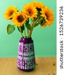 Sunflowers In Purple Vase On...