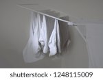 Small photo of (foldout) drying rack: white shirts without man on the clotheshorse from the homemaker, Gray background