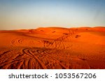 4WD tyre tracks weave through the red sand dunes of the Wahiba Sands desert in Oman on the Arabian Peninsula