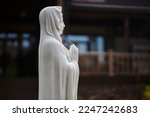 Small photo of Sculpture of Mary Magdalene. Statue of Mary Magdalene in the garden. Sculpture of a lady in the park. Sculpture of the Virgin Mary.