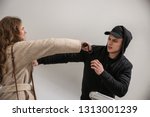 Small photo of Woman with electric shocker defending herself against thief