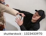 Small photo of Woman with electric shocker defending herself against thief