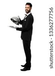Small photo of Waiter with tray and cloche on white background