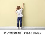 Little Boy Drawing On Color Wall
