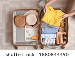 Woman Packing Suitcase At Home. ...