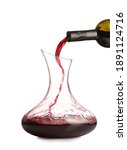 Small photo of Pouring of wine from bottle into decanter on white background