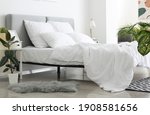 Big comfortable bed with clean linen in room