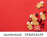 Tasty gingerbread cookies and Christmas decor on color background