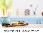 Small photo of Jag, cheese and toasts on table in modern kitchen