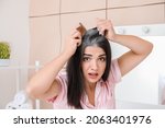 Stressed woman with graying hair at home