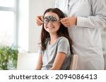 Small photo of Little girl undergoing eye test in clinic