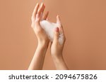 Woman washing hands with soap on color background