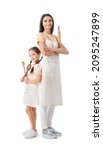 Small photo of Young mother and daughter with kitchen utensils on white background