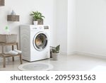 Interior of bathroom with modern washing machine