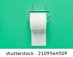 Holder with toilet paper roll on color background