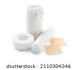 Small photo of Medical plasters, gauze rolls and elastic bandage on white background