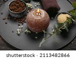 Beautiful spa composition with burning candle on dark wooden background, closeup