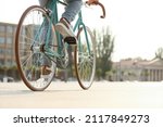 Young man riding bicycle on...