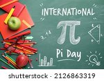 Set of stationery on school chalkboard. International Pi Day