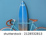 Bicycle and surfboard near color wall