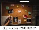 Small photo of Detective processing evidence in FBI agent's office