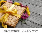 Small photo of Jewish flatbread with flowers on wooden background