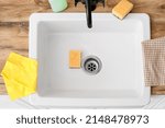 Yellow cleaning sponges in ceramic sink