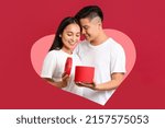 Portrait of happy young Asian couple with gift on red background