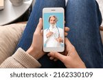 Woman holding smartphone with doctor on screen, closeup. Concept of telemedicine