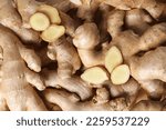 Small photo of Texture of fresh ginger roots as background
