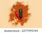 Spray with chili pepper and powder on beige background