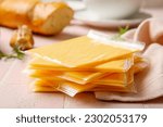 Small photo of Slices of tasty processed cheese with herbs on pink tile background
