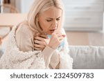 Small photo of Ill mature woman coughing at home, closeup