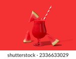 Glass of tasty watermelon juice on red background