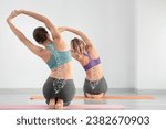 Sporty young women doing yoga in gym. Concept of healthy spine