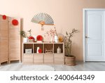 Wooden cabinet with decorations for Chinese New Year celebration in living room