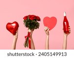 Female hands holding roses, bottle of wine, heart-shaped balloon and gift box on pink background. Valentine's Day celebration