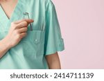 Small photo of Female dentist with dental tools in pocket on pink background, closeup. World Dentist Day