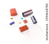 Small photo of Tokyo, Japan - October 29, 2019 : Different type of capacitor on white background. Ceramic and electrolytic capacitor.