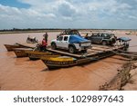 Small photo of Morondava, Madagascar - nov 8 2016 : off-road vehicles embark on barges to cross the Tsiribihina river
