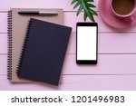 Notebook, mobile smart phone with blank white screen and cup of coffee mock up design template isolated on pink wooden table background. Business technology concept. Top view.