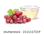 Grapes seed oil in glass bowl isolated on white background. 