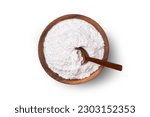 Closeup sugar powder in wooden bowl with spoon isolated on white background. Top view, flat lay