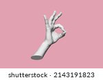 Small photo of The female hand showing the ok gesture isolated on a pink color background. Trendy abstact 3d collage in magazine urban style. Contemporary art. Modern design. Okey hand sign