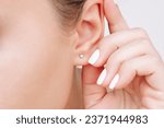 Ear piercing. cropped shot of a ...