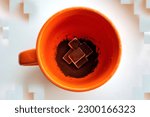 Small photo of Orange cup with coffee and sugar blurred blurred background close-up, a charge of vivacity and energy