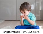 Cute Toddler Boy Blowing Nose...